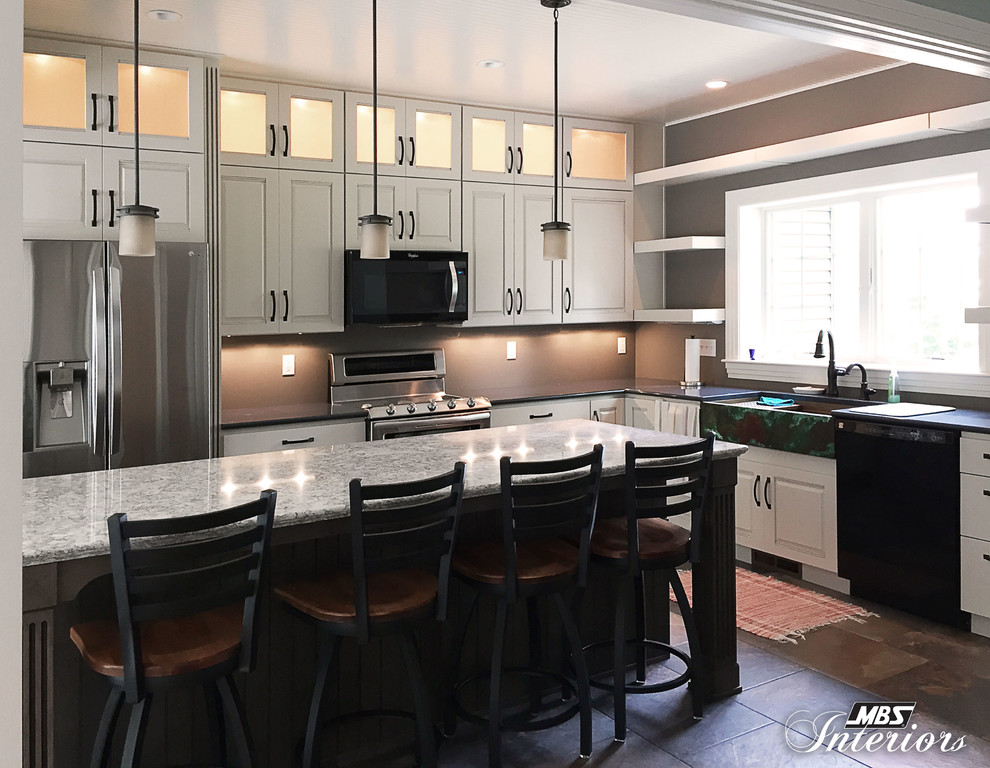 Example of a transitional l-shaped kitchen design with a farmhouse sink, white cabinets, quartz countertops, stainless steel appliances and an island