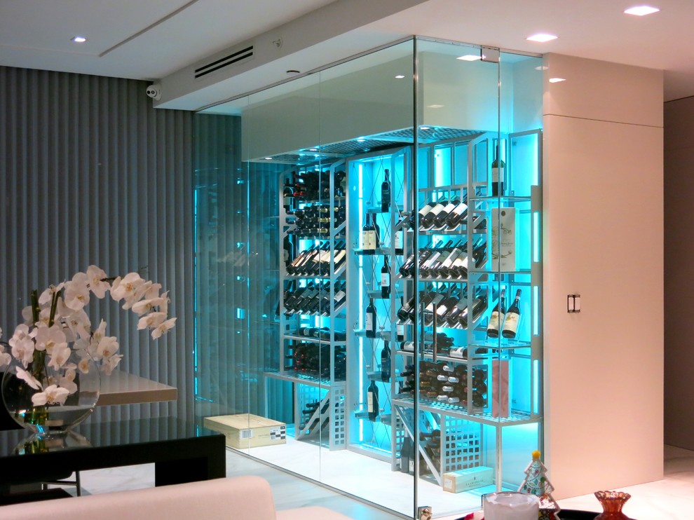 This is an example of a mid-sized contemporary wine cellar in Miami with porcelain floors, display racks and grey floor.