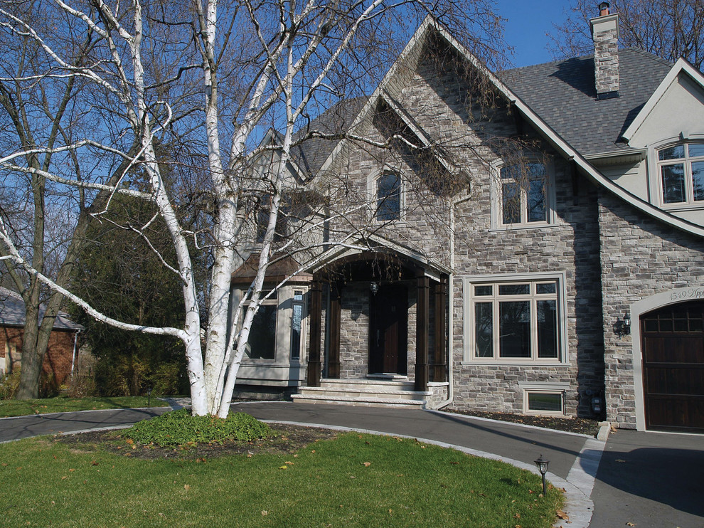 Design ideas for a large traditional two-storey brown exterior in Toronto with stone veneer.