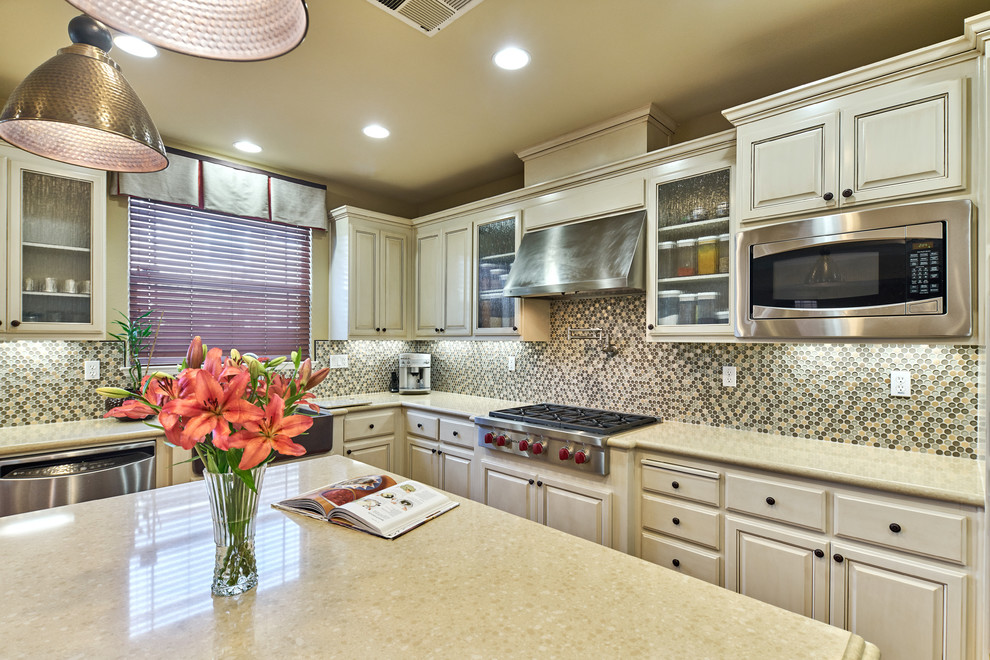 Kitchen pantry - large transitional u-shaped medium tone wood floor and brown floor kitchen pantry idea in San Francisco with a farmhouse sink, raised-panel cabinets, quartz countertops, stainless steel appliances, an island, beige cabinets, multicolored backsplash, mosaic tile backsplash and beige countertops