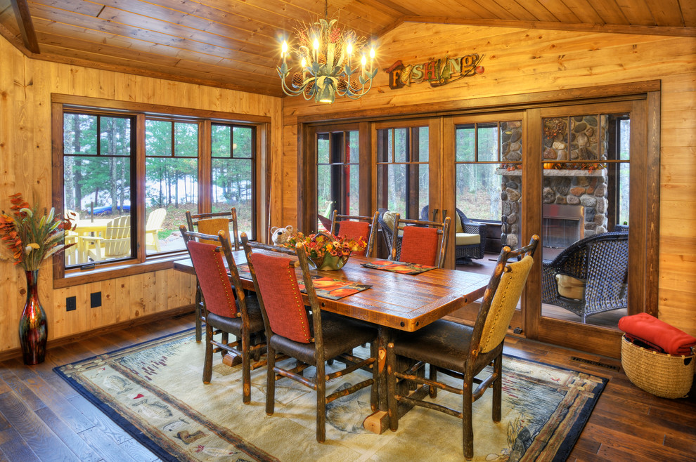 Photo of a country dining room in Other with dark hardwood floors.