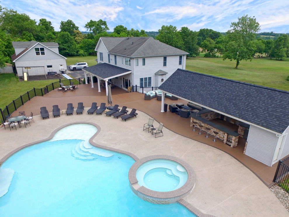 Example of a huge transitional backyard ground level outdoor kitchen deck design