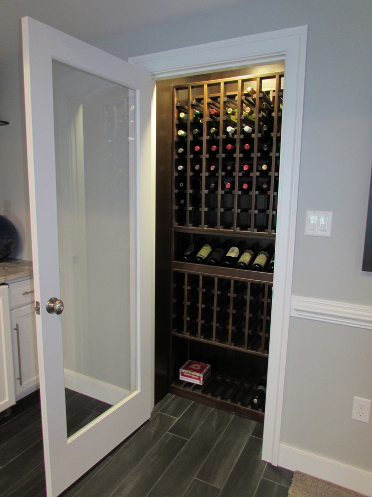 Design ideas for a mid-sized transitional wine cellar in DC Metro with ceramic floors.