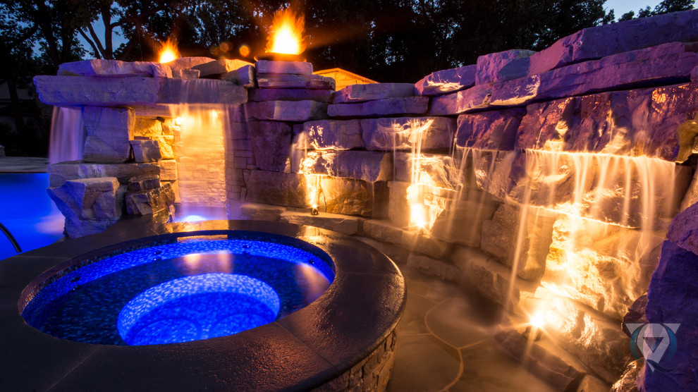 Large mountain style backyard stone and rectangular natural pool fountain photo in Chicago