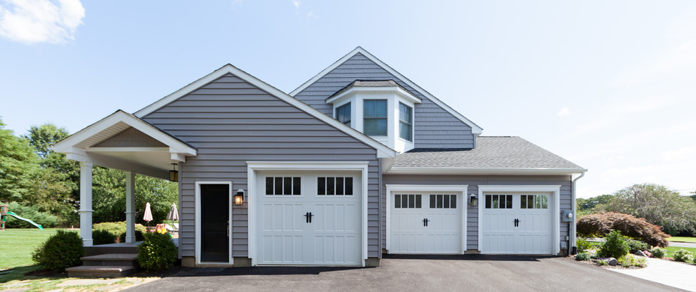 Photo of an expansive traditional attached three-car garage in New York.