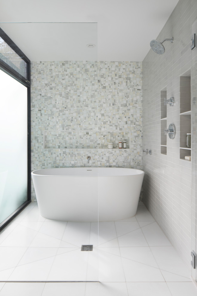 Inspiration for a contemporary wet room bathroom in San Francisco with a freestanding tub, ceramic tile, marble floors, white floor and a hinged shower door.