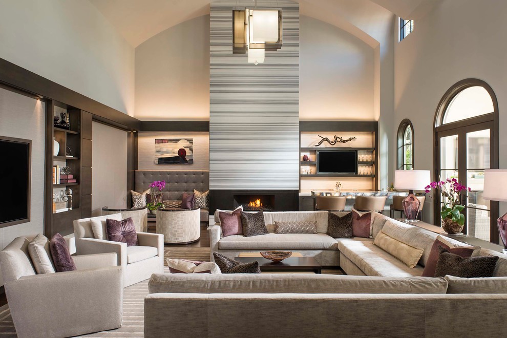 Inspiration for a contemporary open concept family room in Dallas with beige walls, a ribbon fireplace, a home bar and a wall-mounted tv.