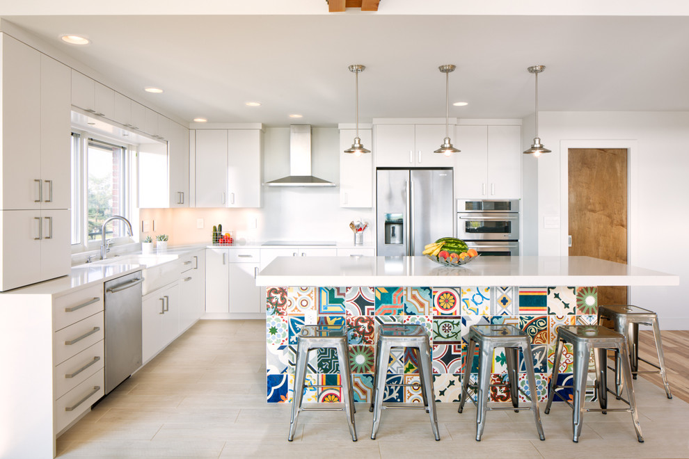 Mid-sized contemporary l-shaped open plan kitchen in Denver with a farmhouse sink, flat-panel cabinets, white cabinets, stainless steel appliances, porcelain floors and with island.