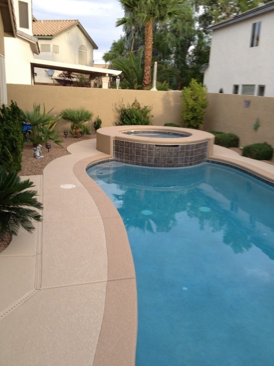 Design ideas for a small transitional backyard custom-shaped pool in Las Vegas with concrete pavers.