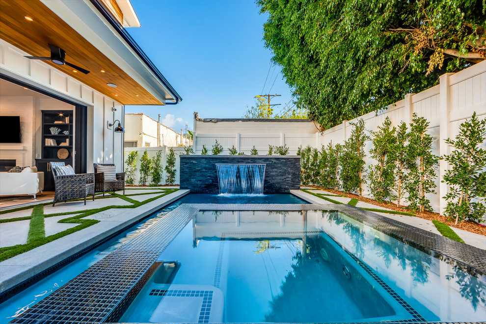 Transitional backyard custom-shaped lap pool in Los Angeles.