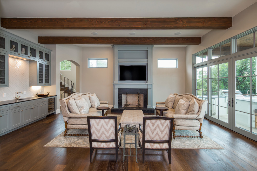 Photo of a mid-sized transitional open concept family room in Austin with beige walls, dark hardwood floors, a standard fireplace and a wall-mounted tv.