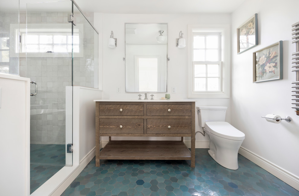 Photo of a mid-sized transitional master bathroom in Portland with flat-panel cabinets, distressed cabinets, a freestanding tub, a shower/bathtub combo, a one-piece toilet, multi-coloured tile, ceramic tile, white walls, ceramic floors, an undermount sink, engineered quartz benchtops, blue floor, a hinged shower door, white benchtops, a niche, a single vanity and a freestanding vanity.