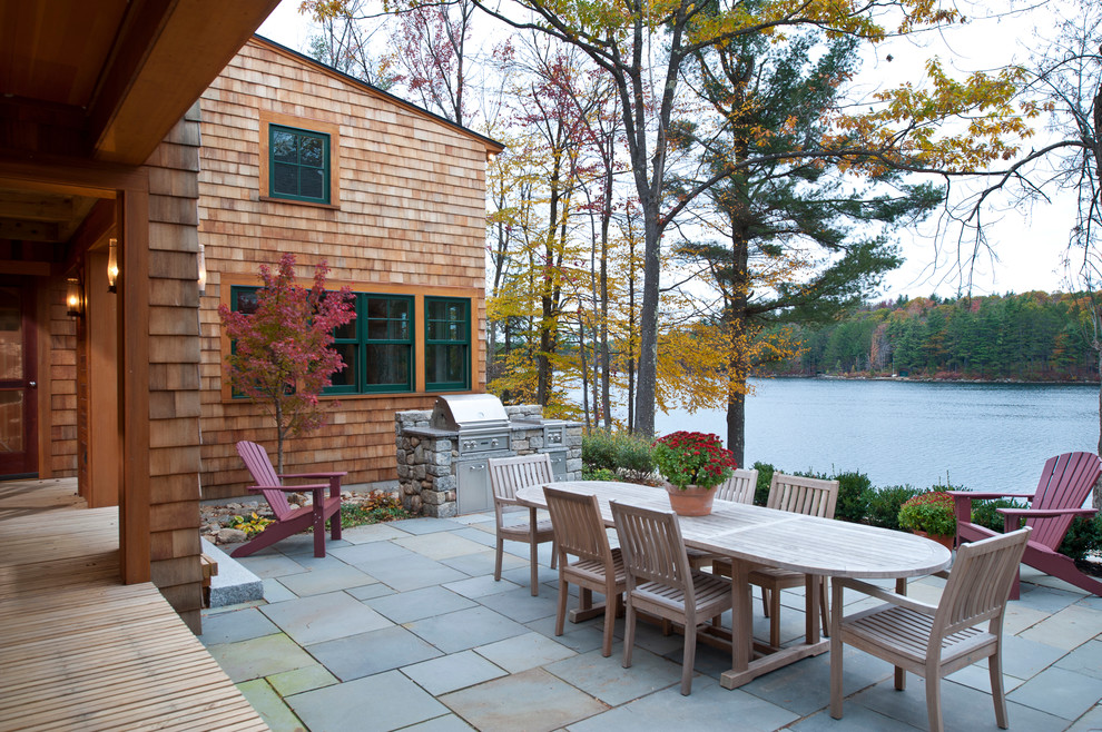 Design ideas for a traditional patio in Boston with natural stone pavers.