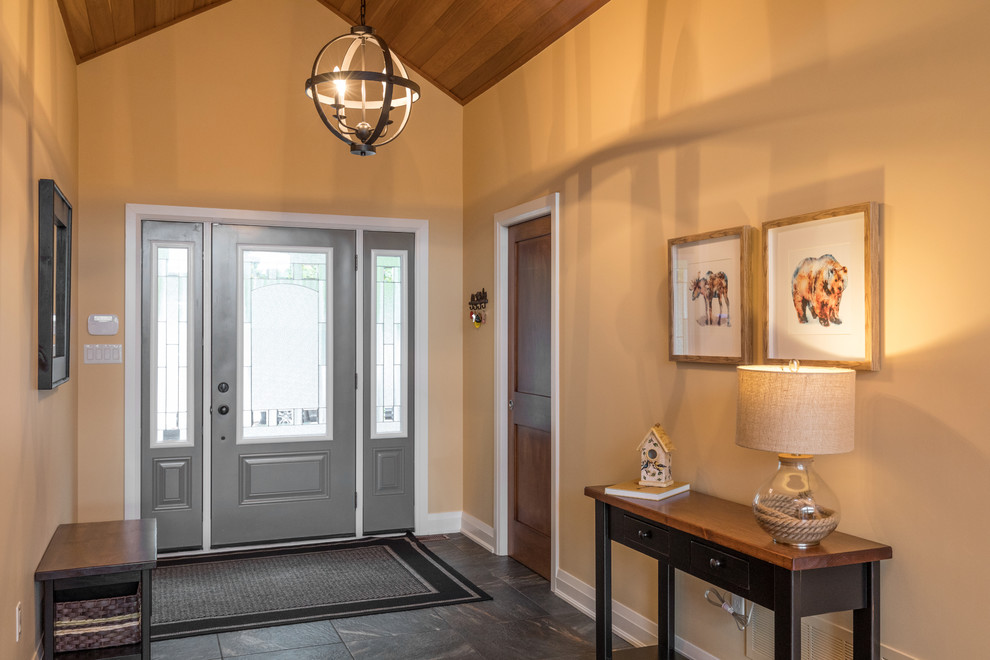 Entry hall - mid-sized transitional gray floor entry hall idea in Toronto with gray walls and a gray front door
