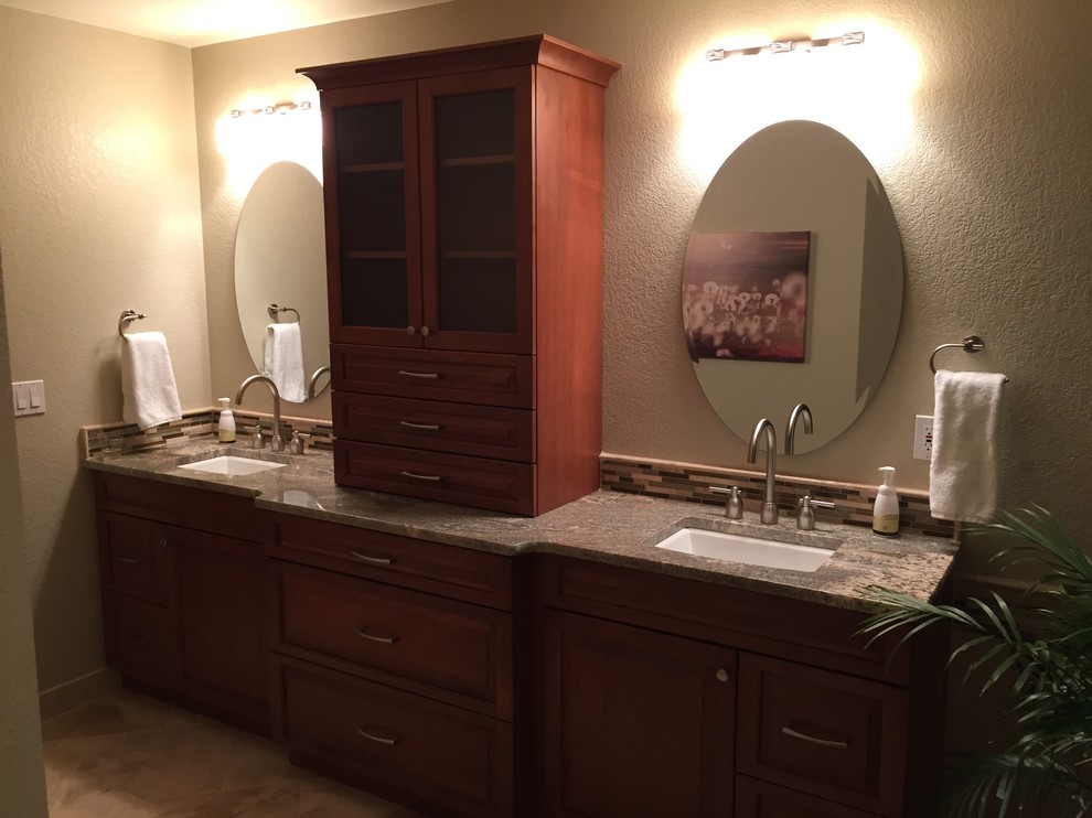 Photo of a mid-sized traditional master bathroom in Denver with an undermount sink, raised-panel cabinets, medium wood cabinets, granite benchtops, a freestanding tub, a corner shower, a two-piece toilet, beige tile, porcelain tile, beige walls and porcelain floors.