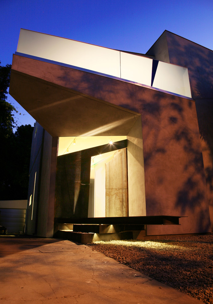 Photo of a mid-sized contemporary two-storey stucco grey exterior in Los Angeles with a flat roof.