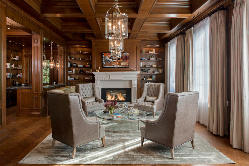 Traditional family room in Los Angeles with a library, medium hardwood floors, a standard fireplace and a wall-mounted tv.