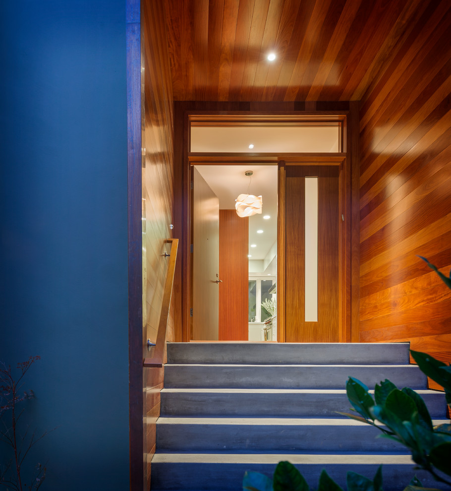 Photo of a contemporary front door in San Francisco with a single front door and a medium wood front door.