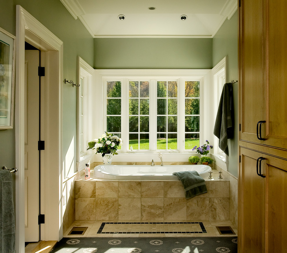 Design ideas for a traditional bathroom in New York with a drop-in tub and green walls.