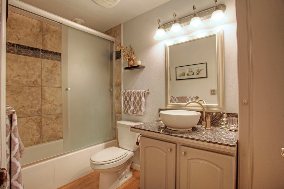 Photo of a mid-sized traditional master bathroom in Seattle with raised-panel cabinets, white cabinets, white tile, cement tile, beige walls, cement tiles, an undermount sink and granite benchtops.