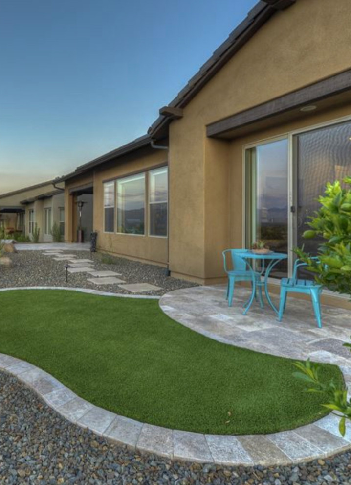 Design ideas for a mid-sized transitional desert and full sun backyard stone landscaping in Phoenix.