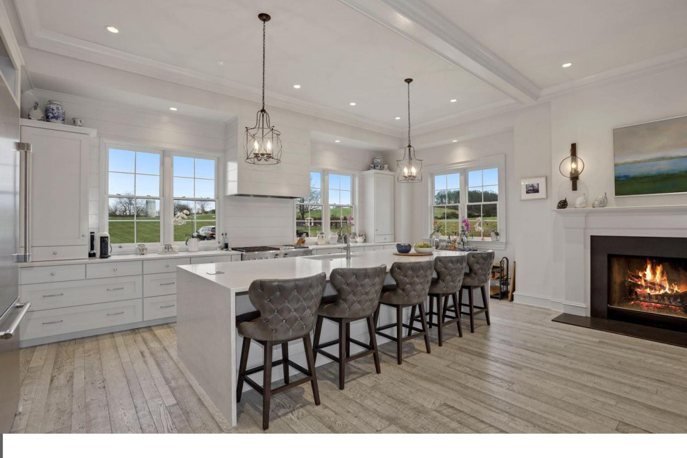 Large transitional single-wall light wood floor eat-in kitchen photo in DC Metro with an undermount sink, shaker cabinets, white cabinets, quartz countertops, stainless steel appliances and an island