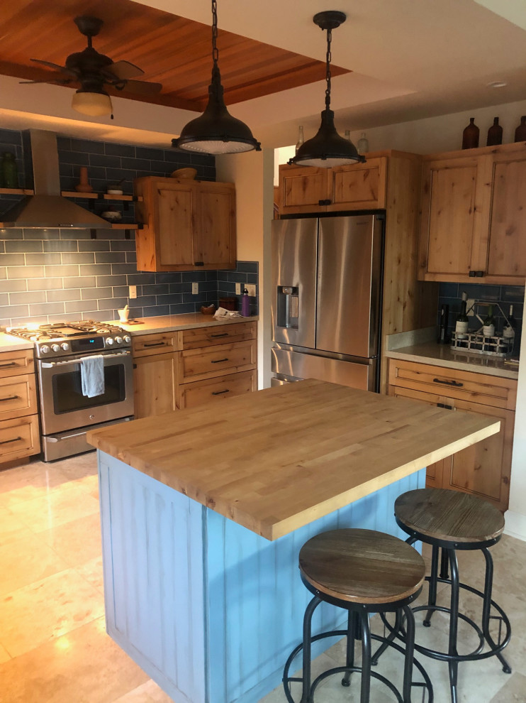 Inspiration for a medium sized rustic u-shaped kitchen/diner in Hawaii with recessed-panel cabinets, medium wood cabinets, engineered stone countertops, blue splashback, ceramic splashback, stainless steel appliances and an island.