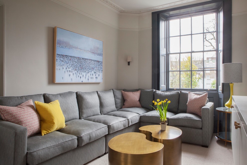 Photo of a transitional living room in London with grey walls and no fireplace.