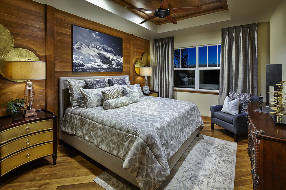 Design ideas for a transitional bedroom in Denver with white walls and medium hardwood floors.