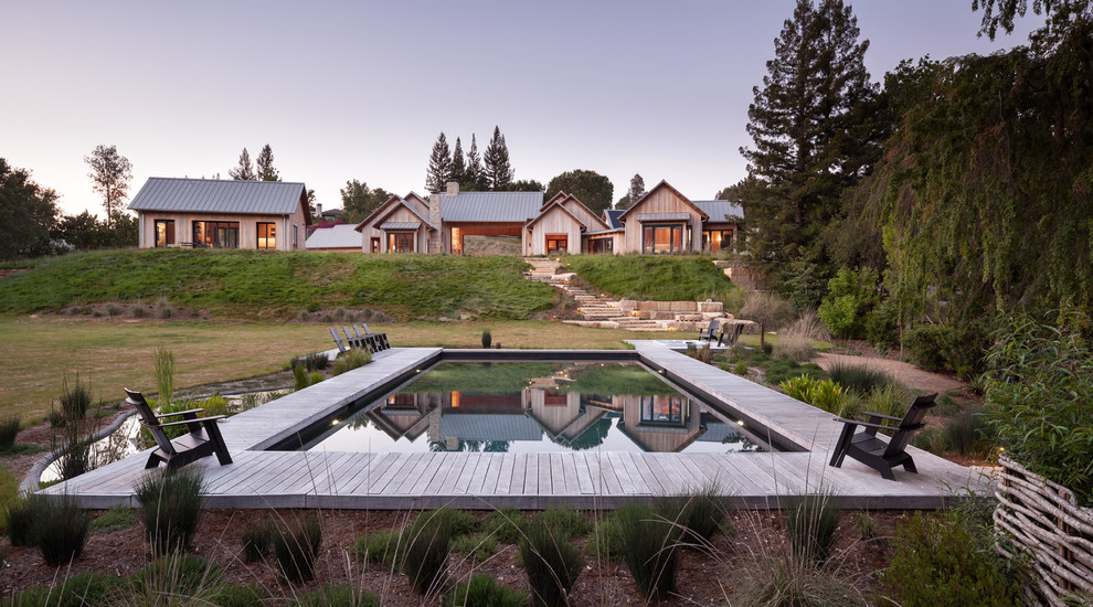 Inspiration for a huge cottage backyard rectangular pool remodel in San Francisco with decking