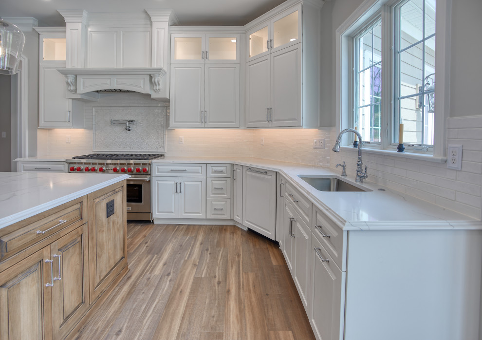 Transitional Kitchen with Two Toned Gathering Island & Archways