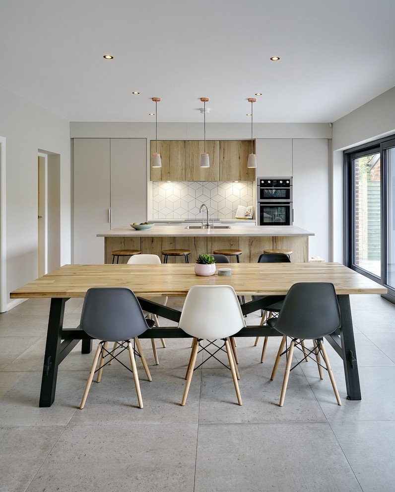 Mid-sized contemporary open plan dining in Belfast with grey floor and beige walls.