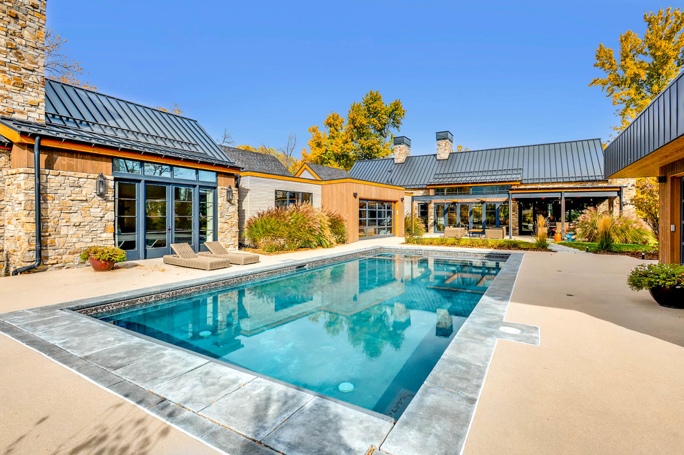 Inspiration for a country courtyard rectangular pool in Denver with concrete pavers.