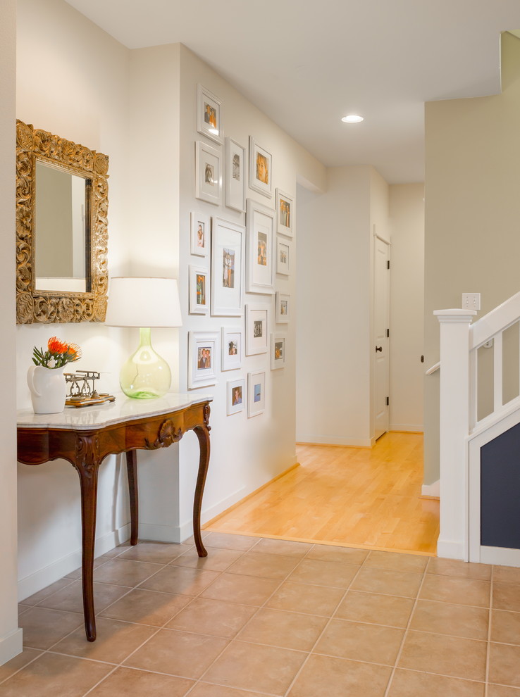 Example of a small transitional porcelain tile entry hall design in Seattle with white walls