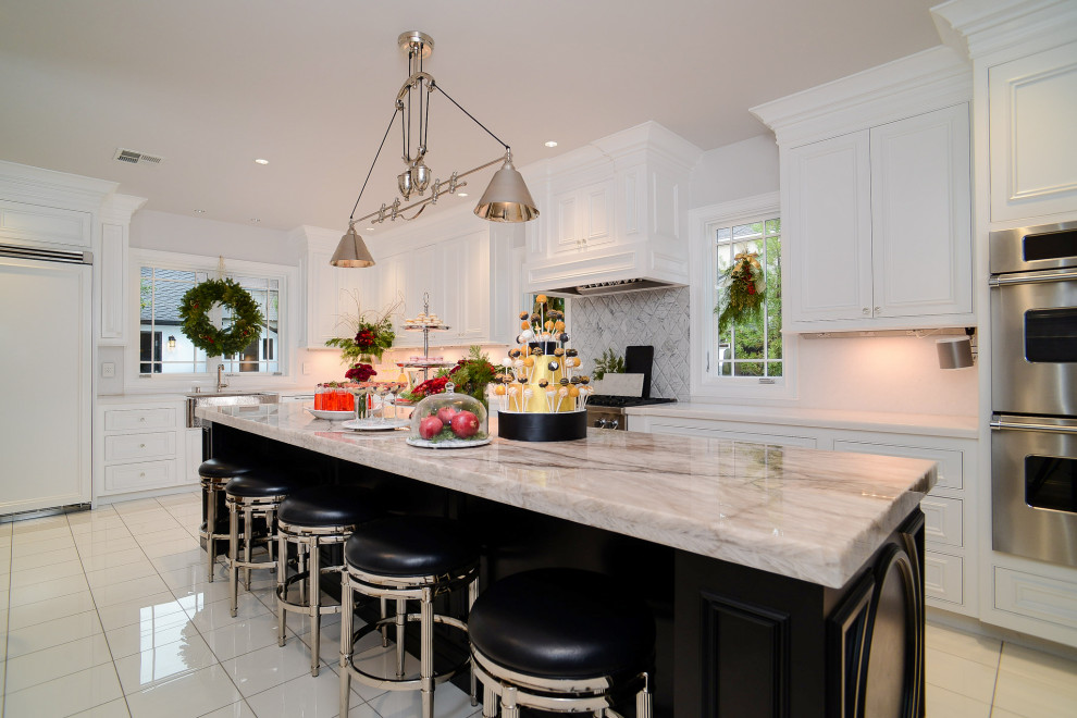 Transitional l-shaped kitchen in Sacramento with beaded inset cabinets, white cabinets, stainless steel appliances, with island, white floor and white benchtop.