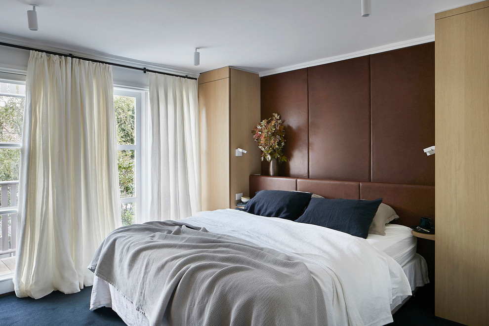 Inspiration for a mid-sized modern master bedroom in Melbourne with white walls, carpet and blue floor.