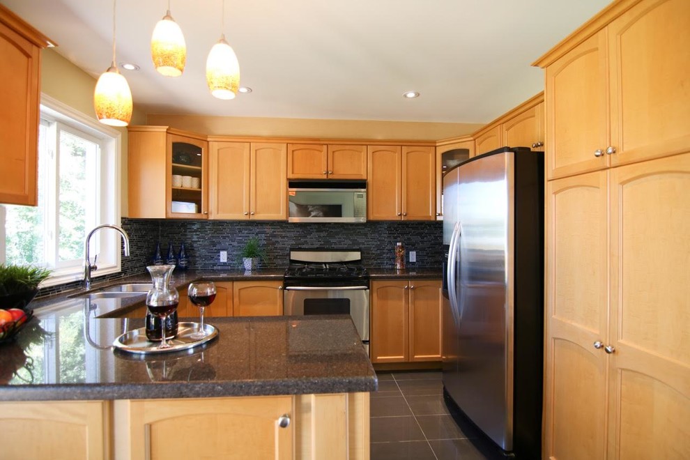 Eat-in kitchen - mid-sized transitional l-shaped porcelain tile and gray floor eat-in kitchen idea in Toronto with an undermount sink, recessed-panel cabinets, light wood cabinets, granite countertops, multicolored backsplash, matchstick tile backsplash, stainless steel appliances and a peninsula