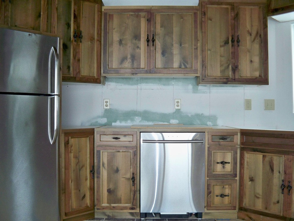 Example of a mountain style eat-in kitchen design with shaker cabinets and distressed cabinets
