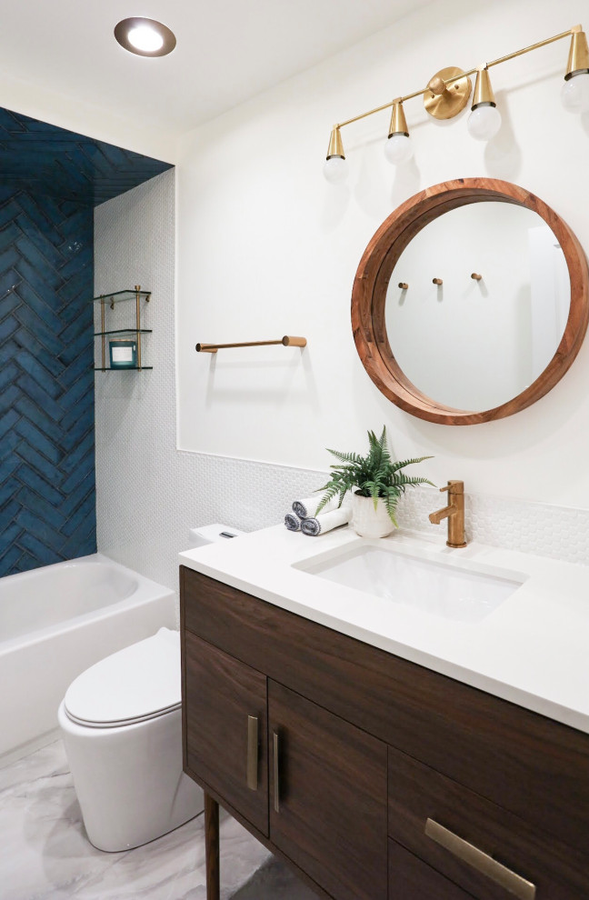 Design ideas for a small transitional master bathroom in Chicago with flat-panel cabinets, brown cabinets, an alcove tub, a shower/bathtub combo, a one-piece toilet, blue tile, ceramic tile, white walls, porcelain floors, a drop-in sink, onyx benchtops, grey floor, a sliding shower screen, white benchtops, an enclosed toilet, a single vanity and a freestanding vanity.