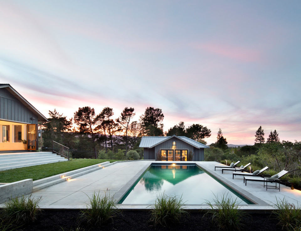 Mid-sized country backyard rectangular lap pool in San Francisco with a pool house and concrete slab.