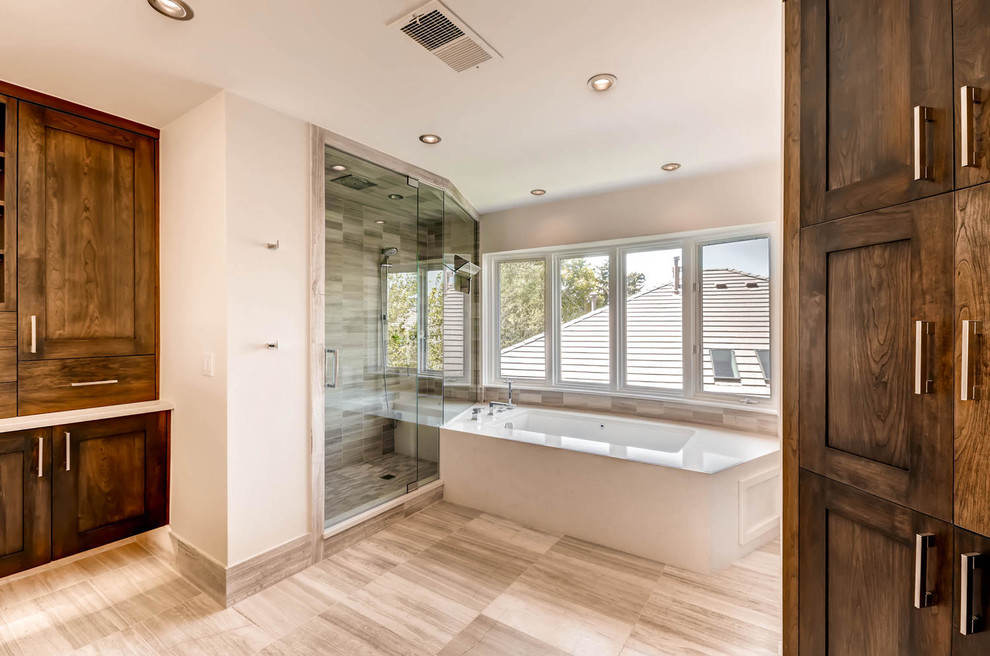 Inspiration for a huge transitional master ceramic tile drop-in bathtub remodel in Denver with shaker cabinets and dark wood cabinets