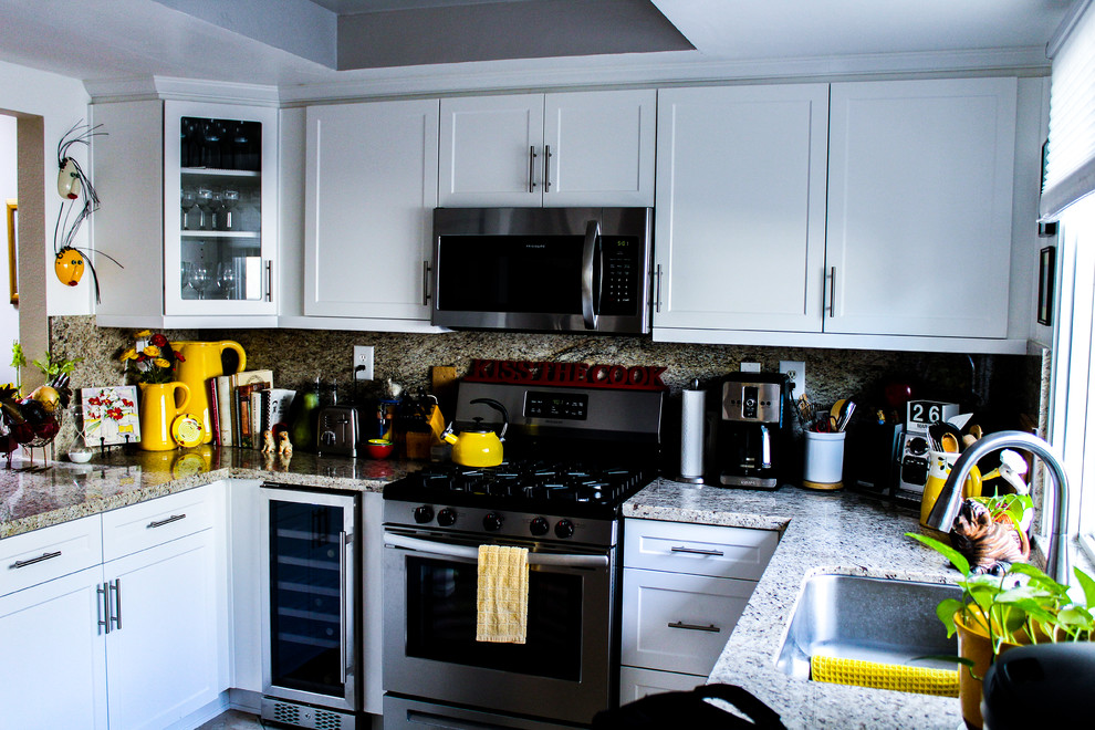 Mid-sized transitional u-shaped porcelain tile and beige floor enclosed kitchen photo with an undermount sink, shaker cabinets, white cabinets, granite countertops, brown backsplash, stone slab backsplash, stainless steel appliances, no island and brown countertops
