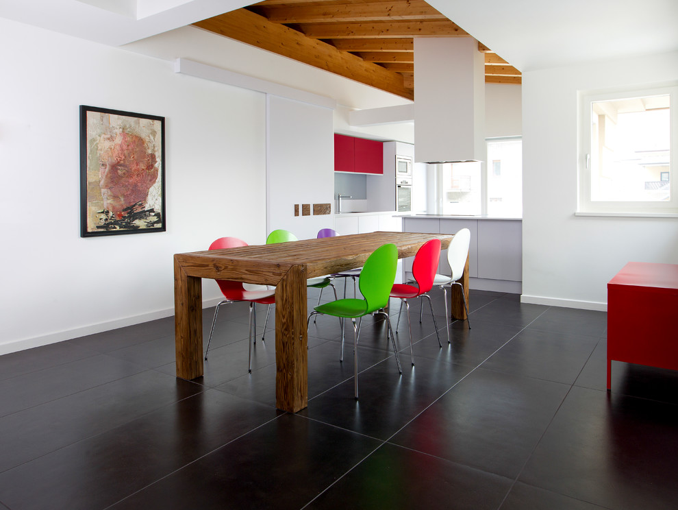 Photo of a contemporary open plan dining in Milan with white walls and black floor.