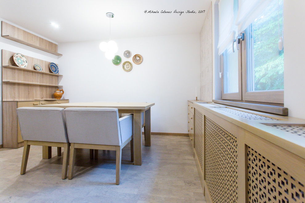Example of a mid-sized transitional l-shaped porcelain tile and beige floor eat-in kitchen design with an integrated sink, raised-panel cabinets, light wood cabinets, wood countertops, beige backsplash, travertine backsplash, stainless steel appliances and no island