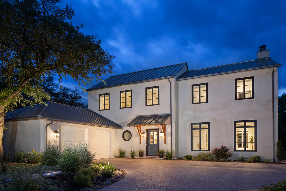 This is an example of a mid-sized traditional two-storey stucco white exterior in Austin.