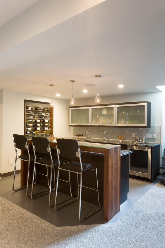 Inspiration for a mid-sized contemporary single-wall seated home bar in Other with an undermount sink, flat-panel cabinets, glass benchtops, blue splashback, glass tile splashback, dark hardwood floors, brown floor and black benchtop.