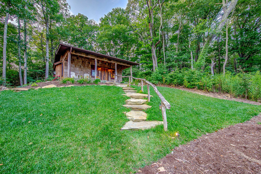 Example of a small mountain style brown one-story mixed siding gable roof design with a mixed material roof