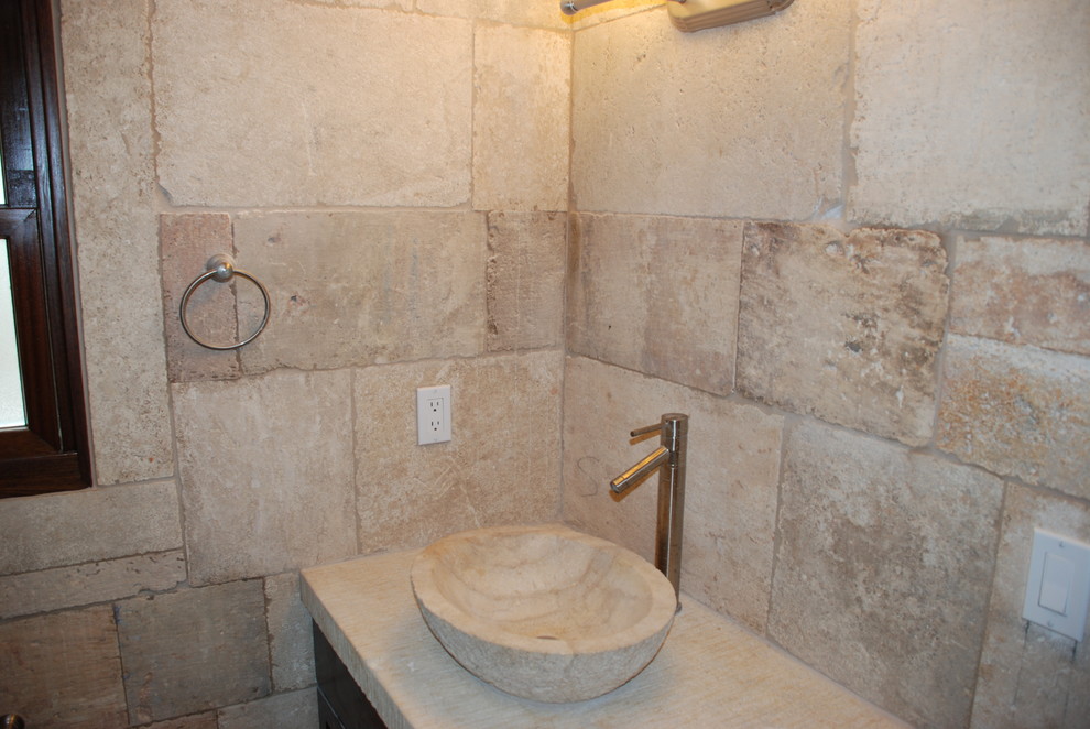Photo of a small mediterranean bathroom in Orange County with multi-coloured walls and limestone floors.
