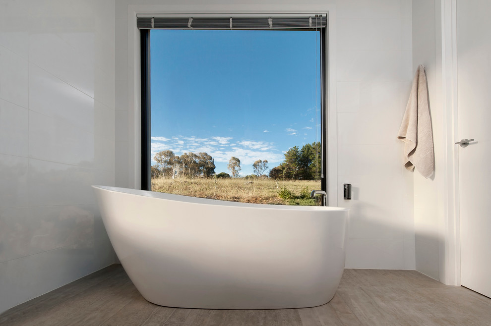 Photo of a large contemporary master bathroom in Canberra - Queanbeyan with a freestanding tub, white walls and ceramic floors.