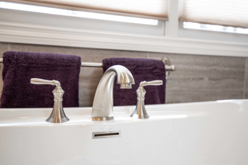 Freestanding bathtub - large transitional master brown tile, beige tile and porcelain tile porcelain tile and beige floor freestanding bathtub idea in Chicago with raised-panel cabinets, white cabinets, beige walls, an undermount sink, granite countertops, a hinged shower door and beige countertops